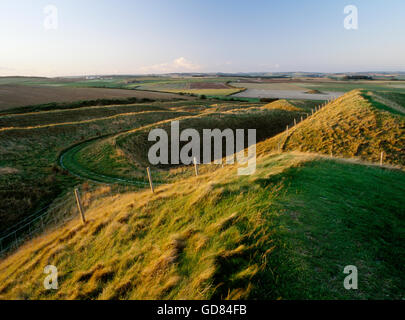 The multiple ditch and bank defences at the western entrance to Maiden Castle near Dorchester Stock Photo