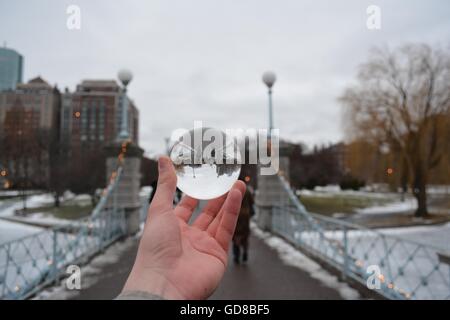 The Boston Public Garden Pedestrian Bridge seen through a crystal ball displaying an iconic landmark in a unique way. Stock Photo