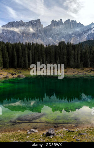 Latemar group reflected in the green waters of Lake Carezza Dolomites Ega valley South Tyrol Trentino Alto Adige Italy Stock Photo