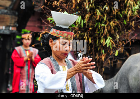 A Traditional Batak Dancer performing a ceremonial dance in Bolon Simanindo Batak Museum Village. Batak stands for the ethnic pe Stock Photo