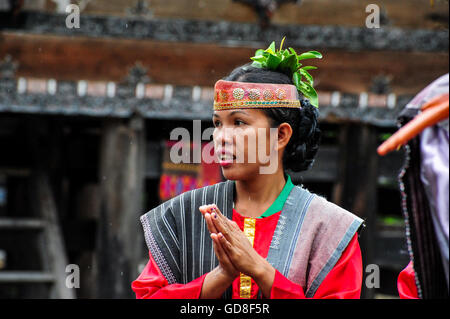 A Traditional Batak Dancer performing a ceremonial dance in Bolon Simanindo Batak Museum Village Stock Photo