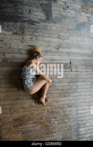 Young Woman Curled Up On Shingle Beach Alone Stock Photo: 19400187 - Alamy