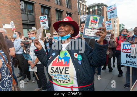 London, UK, 14th July 2016. Healthcare workers and supporters dedicated to saving a publicly funded, delivered and accountable NHS hold up placards at the rally outside St Paul's with speakers including Matt Wrack of the FBU. The event was organised by NHS Solidarity. Peter Marshall/Alamy Live News Stock Photo