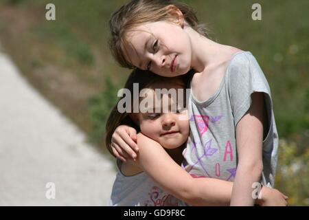 sisters hugging Stock Photo