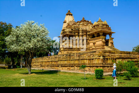 Tourist in front of Chitragupta Hindu temple against blue sky - Khajuraho Madhya Pradesh, India Stock Photo