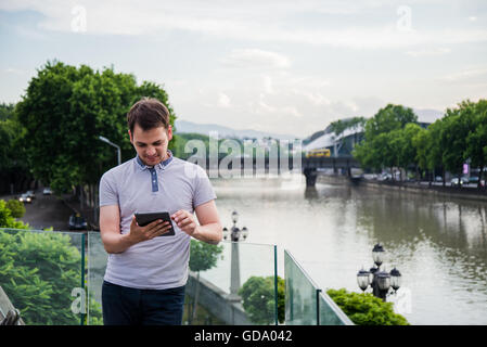 Young man searching information using an tablet computer. Stock Photo