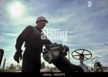 Oil worker at a well head in Edmonton, Alberta – Canada. Stock Photo