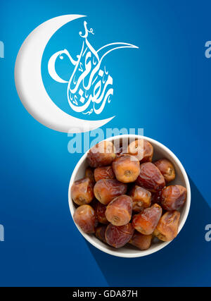 Ramadan Fasting Dates with Crescent over Vivid Blue Background Stock Photo