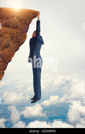 business concept challenge businessman clinging on Stock Photo
