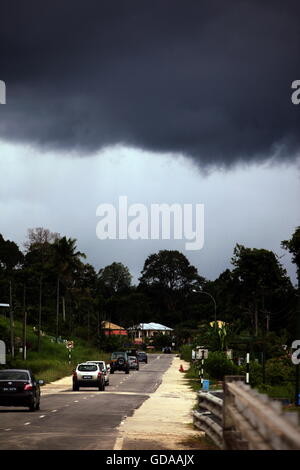 a road by a storm near the city of Bandar seri Begawan in the country of Brunei Darussalam on Borneo in Southeastasia. Stock Photo