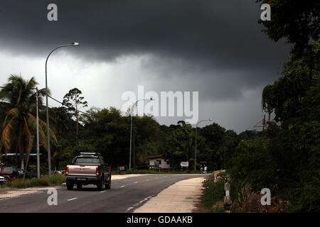 a road by a storm near the city of Bandar seri Begawan in the country of Brunei Darussalam on Borneo in Southeastasia. Stock Photo