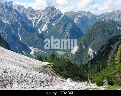 Italy, Trentino-Alto Adige, Sextener Dolomites, Woman hiking in wooded mountain landscape, on the way to the Herrenstein Stock Photo