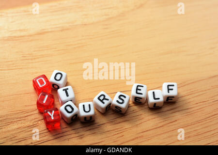 Term DIY spelled from toy cubes, dice letters on wooden background Stock Photo