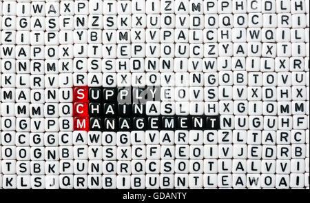 SCM Supply Chain Management written on black and white  dices Stock Photo