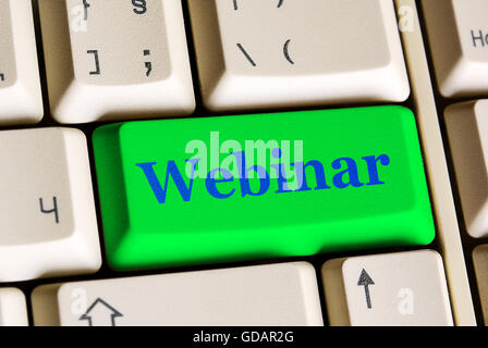 Green  computer   button and text Webinar  on white keyboard Stock Photo