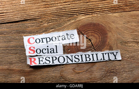 Corporate social responsibility (CSR) concept on paper on wood Stock Photo