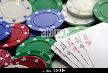 four aces with casino chips on green table clot Stock Photo