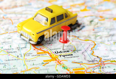 Close up of  Udine  , Italy map with red pin and a taxi   - Travel concept Stock Photo