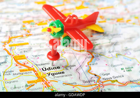 Close up of  Udine  , Italy map with red pin and airplane  - Travel concept Stock Photo