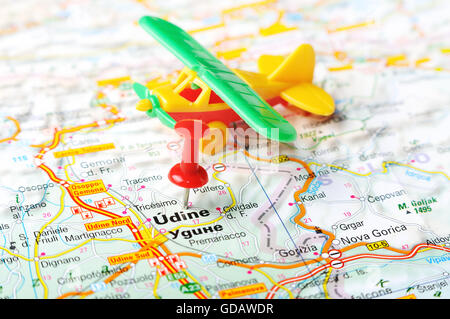 Close up of  Udine  , Italy map with red pin and airplane  - Travel concept Stock Photo