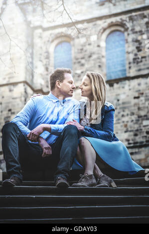 young couple sitting on stairs Stock Photo