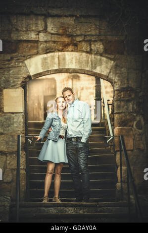 young loving couple standing on stairs Stock Photo