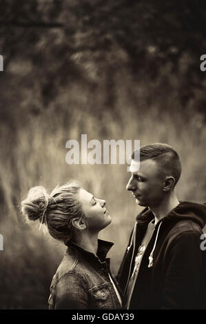 young couple in nature looking at each other with love Stock Photo