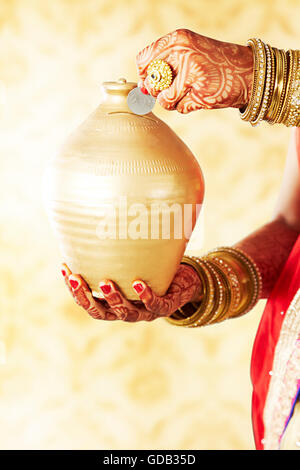 1 indian Adult Woman Bride Piggy Bank money Inserting showing Stock Photo