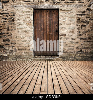 Abstract empty room interior background with brow wooden floor and closed door in brick wall Stock Photo
