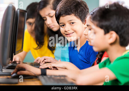5 kids Girls and Boys School Student Sitting Classroom Computer Studying Stock Photo