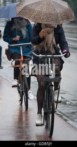 Cycling in the rain in Amsterdam Stock Photo