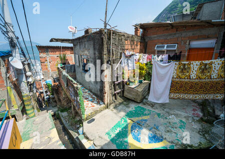 RIO DE JANEIRO - MARCH 31, 2016: Laundry hangs on staircase at the Santa Marta Community (favela), a target for favela tourism. Stock Photo