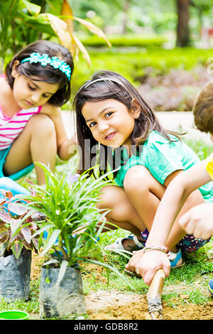 3 indians Kids Friends park Plant Planting Stock Photo