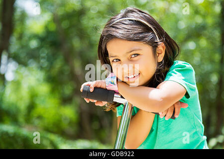1 indian Kid girl park Push Scooter standing Stock Photo
