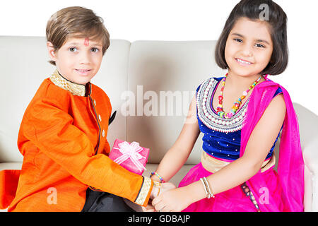 2 indians Kids brother and sister Raksha Bandhan Festival hand Tying Rakhi Stock Photo