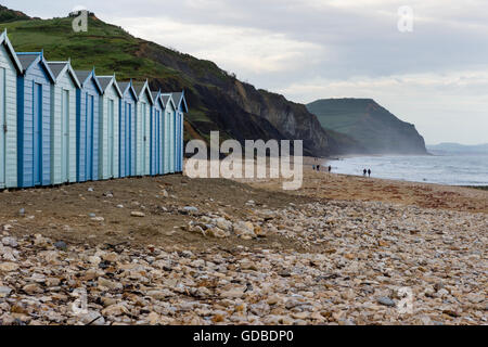 Beach huts on the shingle beach at Charmouth, Dorset, UK, on the Jurassic Coast UNESCO World Heritage site. Stock Photo