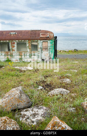 Old abandoned train wagon on the shore of lake Sevan, Armenia. Stock Photo