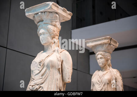 Caryatids of Erechtheum statues seen at the Archaeological Museum of Acropolis, in the Greek capital city of Athens. The Acropolis Museum is an archaeological museum focused on the findings of the archaeological site of the Acropolis of Athens. The museum was built to house every artifact found on the rock and on the surrounding slopes, from the Greek Bronze Age to Roman and Byzantine Greece. It also lies over the ruins of a part of Roman and early Byzantine Athens. Stock Photo
