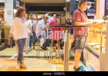 People eating and drinking at bars inside Mercado del Puerto (port market) in Las Palmas, Gran Canaria, Canary Islands, Spain Stock Photo