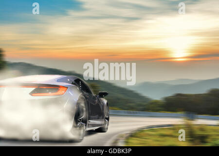 Brandless sport car speeding along the highway at sunset. Due to drifting at the corner, there is a lot of smoke from the wheels Stock Photo