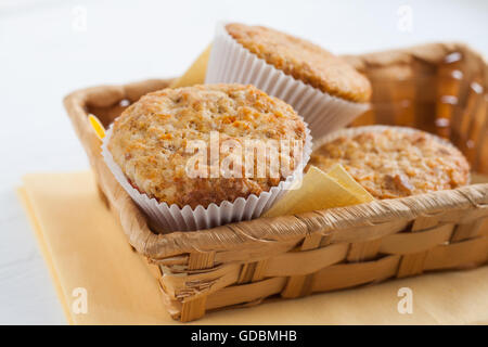 bright fragrant pumpkin cup cakes, muffins in a basket. Stock Photo