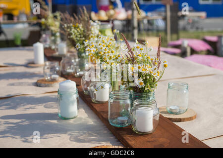 Beautiful table set with candles and flowers for a festive event, party or wedding reception Stock Photo