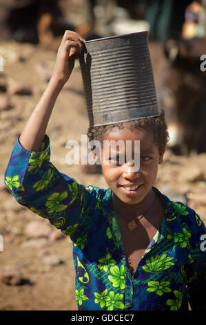 Ethiopian girl with a tin can on her head, Lalibela, Ethiopia Stock Photo