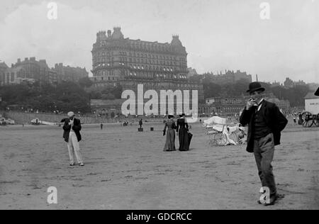 Beach scene including The Grand Hotel, South Bay, Scarborough, Yorkshire c1910. Photograph by Tony Henshaw Stock Photo