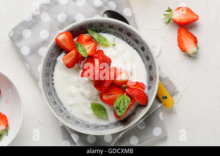 rice pudding bowl with strawberry, food top view Stock Photo