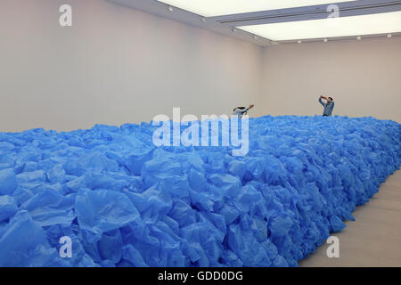 visitors posing with art installation (everything must go) at the saatchi gallery london Stock Photo