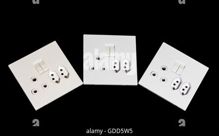Close up of beige and white multipurpose wall mount sockets and switches arc  arrangement on black background Stock Photo
