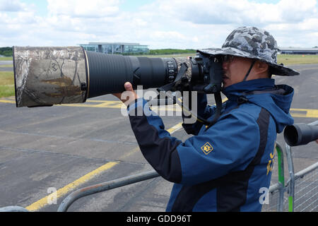 A photographer with a large lens. Stock Photo