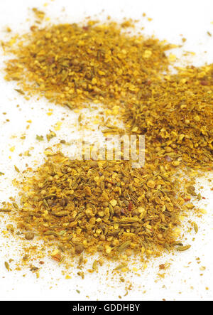 CURRY POWDER AGAINST WHITE BACKGROUND Stock Photo