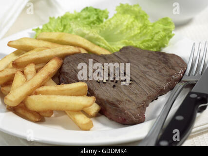 PLATE WITH STEAK, SALAD AND FRENCH FRIES Stock Photo